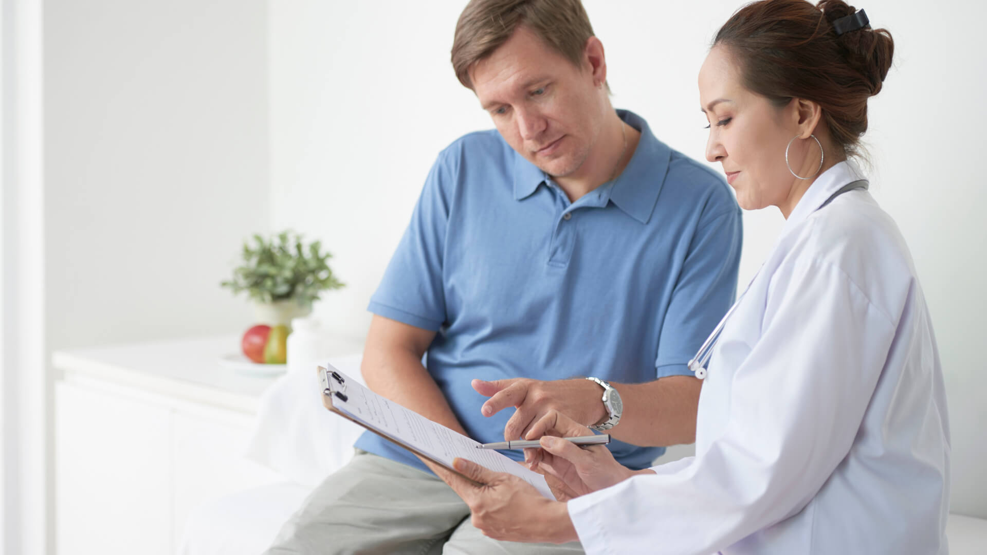 Doctor Checking Notes with Patient